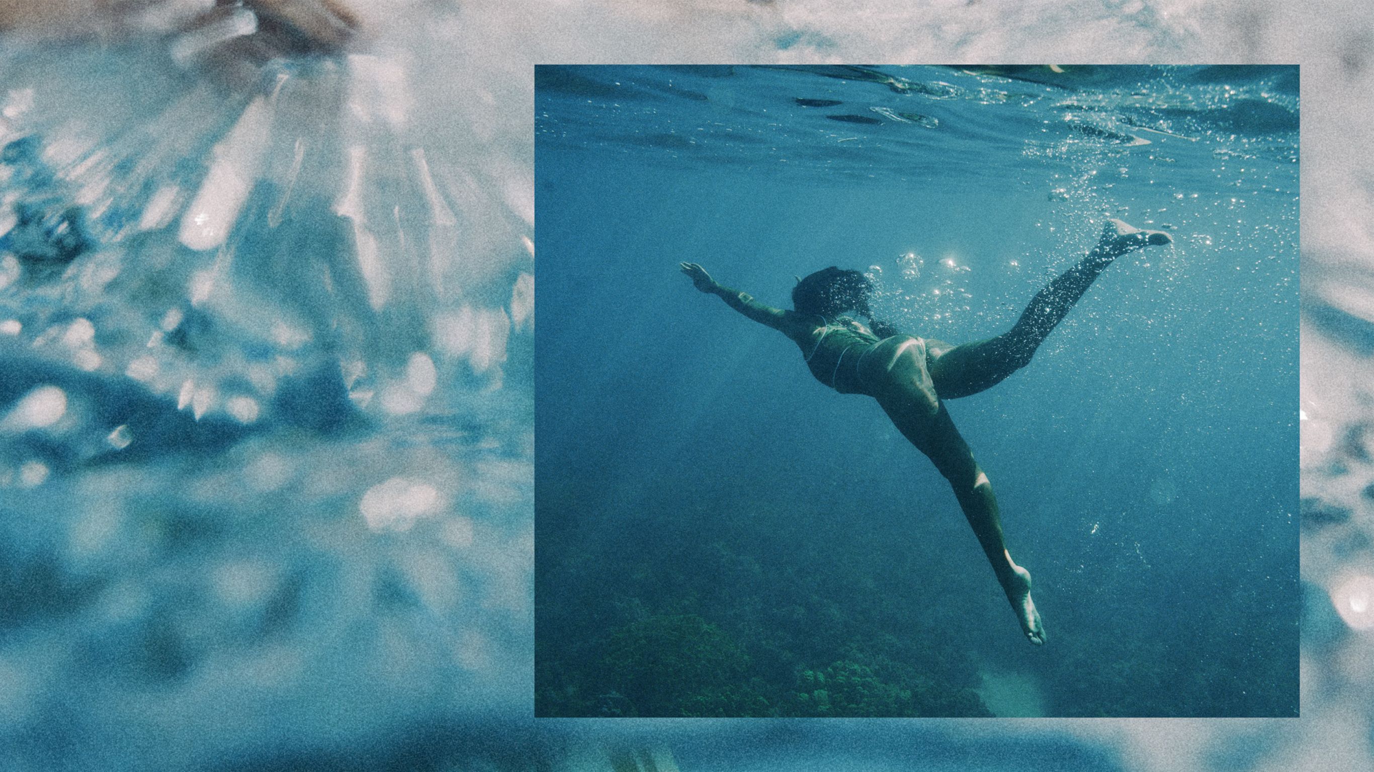 A person swimming underwater in clear blue  water.